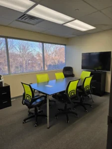 Classroom meeting space at Inspection21 Paramus NJ campus with table, chairs, and large windows